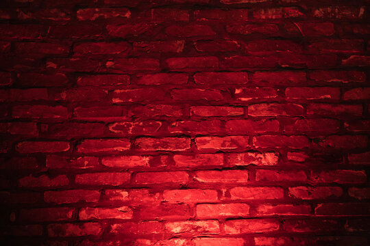 Background of empty brick wall with red neon light