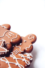 Tasty homemade Christmas gingerbread cookie of various shapes with sugar glaze on white background with copy space. Happy Holidays