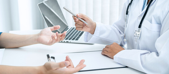 Doctor hold pen and patient discussing something in medical clinic