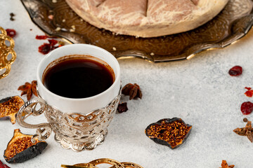 Cup of coffee and turkish pastries on dark surface