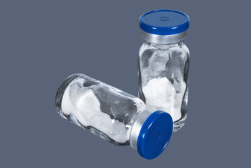 Medical vials with white powder vaccine