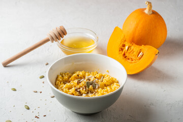 Ripe, fresh pumpkin and porridge from it, honey. Homemade food..healthy breakfast