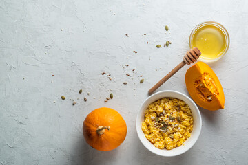 Obraz na płótnie Canvas Ripe, fresh pumpkin and porridge from it, honey. Homemade food..healthy breakfast