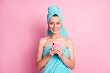 Portrait of funny pretty young lady hold telephone wear teal towels isolated on pink color background