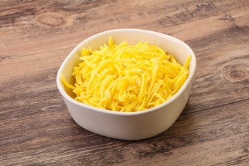 Shredded yellow cheese in the bowl