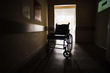 The wheelchair in the middle of an empty corridor in the hospital