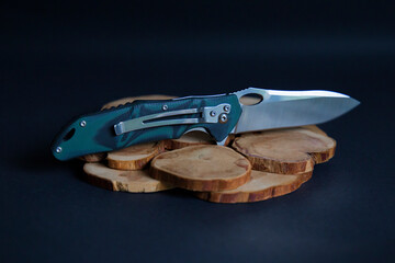 
Folding knife on wood