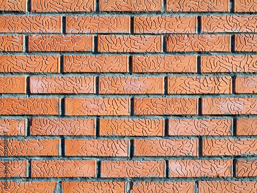 Poster modern brickwork with decorative red bricks. there is a pattern of wavy grooves on the surface of th