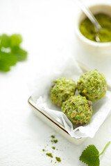 On a white table turkish sweet nuts.
Handmade pistachio dessert.