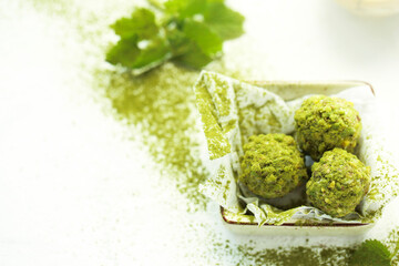 On a white table turkish sweet nuts.
Handmade pistachio dessert.