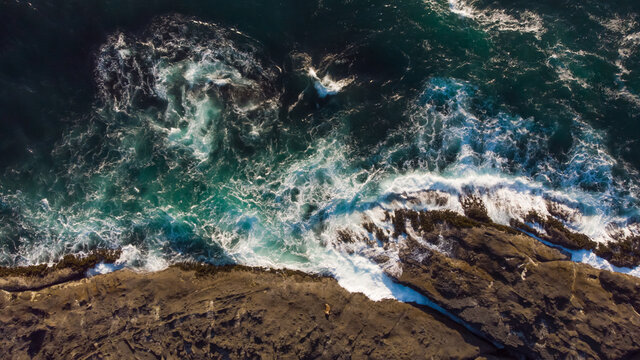 Aerial top view of ocean waves and fantastic rocky coast. Discover the world concept. Natural landscape. Wallpaper design.