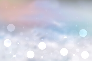 Abstract blurred festive winter christmas background with shiny blue and white bokeh lighted snow landscape with stars and pink cloudy sky.