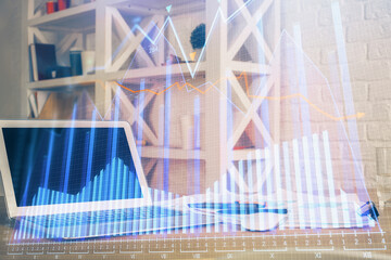 Financial graph colorful drawing and table with computer on background. Double exposure. Concept of...