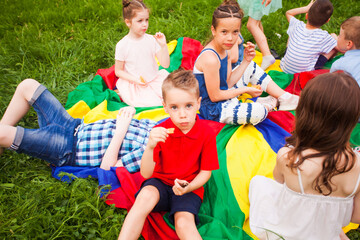 The children in the camp have a snack while traveling