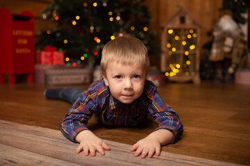 Cute little boy in festive decorated room for Christmas