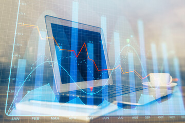 Financial chart drawing and table with computer on background. Double exposure. Concept of...
