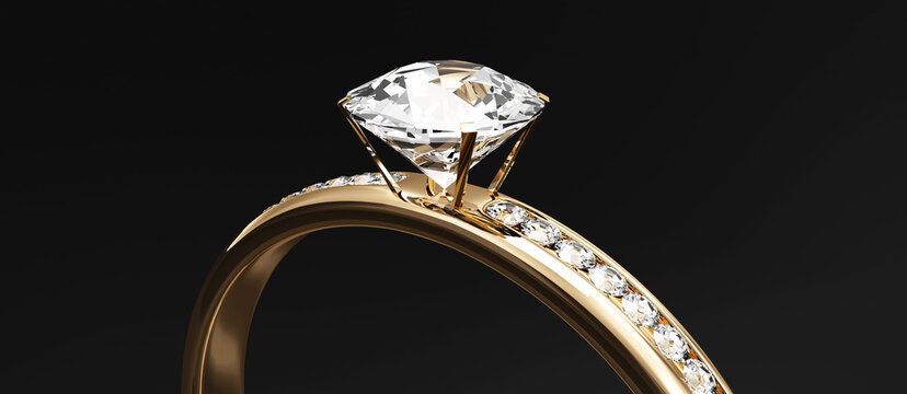 Golden Wedding Ring with Diamonds on black studio background.