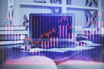 Financial graph colorful drawing and table with computer on background. Multi exposure. Concept of...