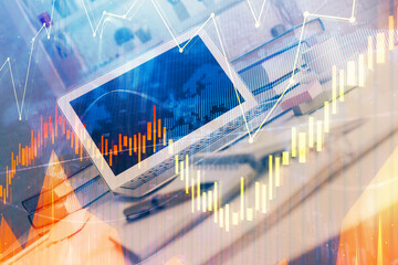 Stock market graph and table with computer background. Multi exposure. Concept of financial analysis.