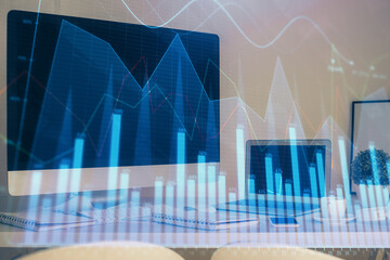 Stock market graph and table with computer background. Double exposure. Concept of financial analysis.