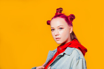 Young model with trendy makeup on yellow background