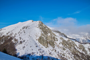 Winter landscape high in the mountains with blue sky