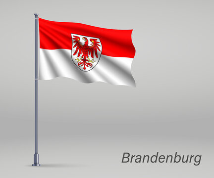 Waving flag of Brandenburg - state of Germany on flagpole. Template for independence day poster design