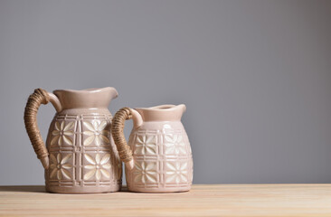 Two beige ceramic jugs for home decoration and flowers