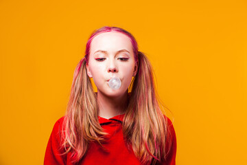 Beautiful girl releifs stress by blowing bubble gum ball