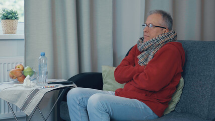 Obraz premium The man has a cold, he has a strong runny nose, cough and fever.