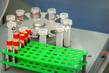 Test tubes with blood samples in rack and in centrifuge machine in the lab