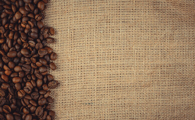 Roasted coffee beans on burlap. Background for coffee shops and store websites