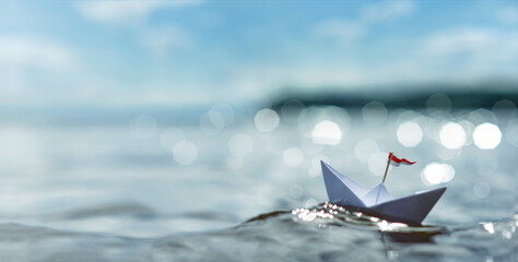 small paper ship on the high seas