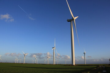 Wind farm turbines that produce electricity energy. Windmill Wind power technology productions Wind...