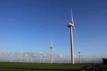Wind farm turbines that produce electricity energy. Windmill Wind power technology productions Wind...