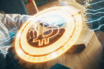 Cryptocurrency hologram, bitcoin, ico theme over hands taking notes background. Concept of blockchain. Multi exposure