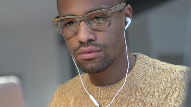 Portrait of african american trendy guy in a distant online call