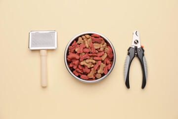 Pet care accessories and bowl with dry pet food on color background