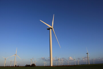 Wind farm turbines that produce electricity energy. Windmill Wind power technology productions Wind...
