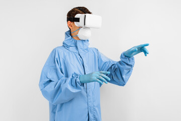 male doctor in a medical mask and uniform to protect against coronavirus, using virtual reality...