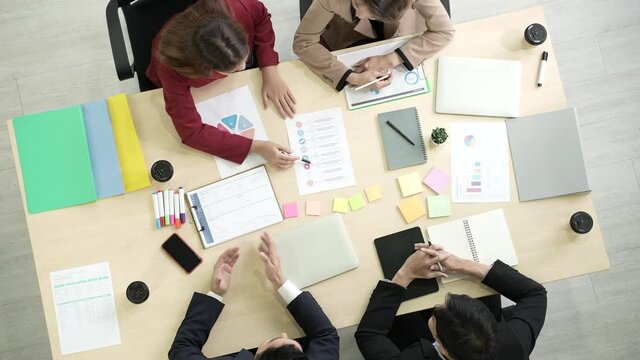 Colleagues business person talking and discussing the issue at business partner team  meeting in a modern office, top view