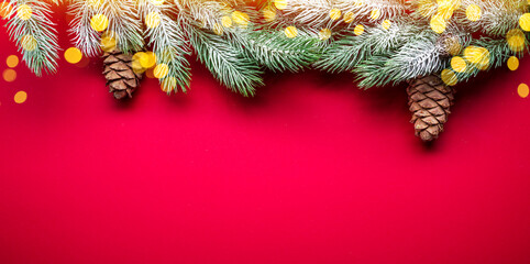 Red New Year or Christmas background with fir branch and christmas decor.