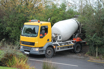 Concrete mixer truck reversing into a domestic driveway UK