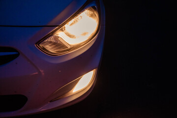 headlights of a white car at dusk