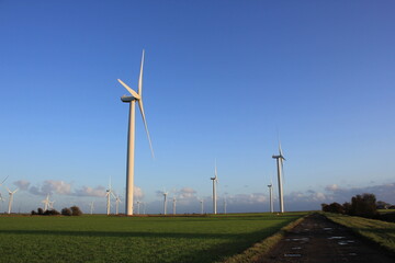 Wind farm turbines that produce electricity energy. Windmill Wind power technology productions Wind...