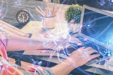 Neuron hologram with man working on computer on background. Education concept. Double exposure.