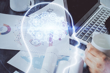 Businessman with computer background with brain theme hologram. Concept of brainstorm. Multi exposure.