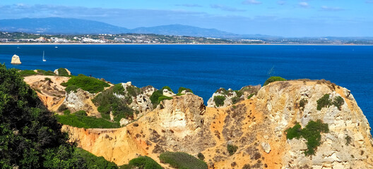 The beauty of Portugal - hiking the wild cliffs in Lagos at the blue Atlantic ocean in Portugal