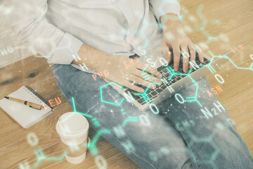Science formula hologram with man working on computer on background. Education concept. Double...