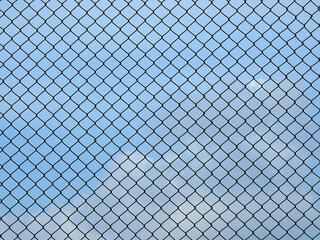 wire mesh of fence wih blue sky background